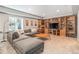 Spacious living room featuring a comfortable sectional sofa and built-in bookshelves at 10994 Shadowbrook Cir, Highlands Ranch, CO 80130