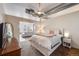 Bright bedroom with ceiling fan, modern decor, and view into adjacent room at 1521 Central St # 2B, Denver, CO 80211