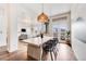 Open-concept dining area features hardwood floors, modern lighting, and views into the living area and outdoor balcony at 1521 Central St # 2B, Denver, CO 80211