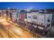 Townhome exterior showing well-lit sidewalks, bare trees and street lights at 1521 Central St # 2B, Denver, CO 80211