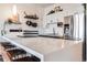 Bright kitchen with stainless steel appliances, white cabinets, and a large quartz island with bar seating at 1521 Central St # 2B, Denver, CO 80211