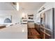 Modern kitchen featuring stainless appliances, a large island with seating, and open shelving at 1521 Central St # 2B, Denver, CO 80211