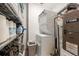 Efficient laundry area features stacked washer/dryer and shelving for organized storage at 1521 Central St # 2B, Denver, CO 80211