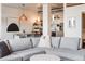 Open-concept living space with modern furnishings and view of dining area and kitchen at 1521 Central St # 2B, Denver, CO 80211