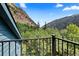 Balcony view overlooking lush green mountains and trees with a blue sky backdrop at 205 Loop Dr, Georgetown, CO 80444