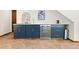 Stylish bar area featuring blue cabinetry, a wine fridge, and a unique stone floor at 205 Loop Dr, Georgetown, CO 80444