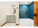 Stylish bathroom with blue tiled shower, modern vanity, and patterned floors at 205 Loop Dr, Georgetown, CO 80444