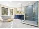 Luxurious bathroom features a soaking tub, a walk-in shower with blue tiling and double vanity at 205 Loop Dr, Georgetown, CO 80444