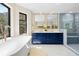 Bright bathroom boasts a soaking tub, dual sinks, vanity, and a glass-enclosed shower at 205 Loop Dr, Georgetown, CO 80444