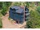 Aerial view of a blue two-story home with dark roof, multiple balconies, and beautiful natural surroundings at 205 Loop Dr, Georgetown, CO 80444