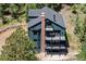 Three-story exterior elevation of mountain home with a brick chimney and multiple balconies at 205 Loop Dr, Georgetown, CO 80444