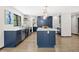 Modern kitchen with stainless steel appliances, island, and bright white countertops and navy blue cabinets at 205 Loop Dr, Georgetown, CO 80444