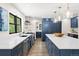 Kitchen features stainless steel appliances, a center island, and navy blue cabinetry at 205 Loop Dr, Georgetown, CO 80444
