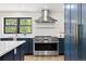 A modern kitchen with stainless steel appliances, a professional range, and a large window at 205 Loop Dr, Georgetown, CO 80444