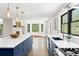 Bright kitchen with white countertops, blue cabinets, stainless steel appliances, and large windows at 205 Loop Dr, Georgetown, CO 80444