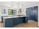 The kitchen offers an island with quartz countertops, stainless appliances, and navy blue cabinets at 205 Loop Dr, Georgetown, CO 80444