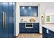 Custom kitchen with navy blue cabinets, quartz counters, a microwave, and hardwood floors at 205 Loop Dr, Georgetown, CO 80444