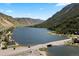 Picturesque aerial view of a lake surrounded by mountains, trees, and connecting roadways at 205 Loop Dr, Georgetown, CO 80444