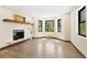 Bright living room with fireplace, hardwood floors, and large windows overlooking a wooded area at 205 Loop Dr, Georgetown, CO 80444