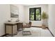 Bright home office featuring a modern desk, leather chair, and large window with views of greenery at 205 Loop Dr, Georgetown, CO 80444
