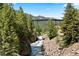 Scenic river view with a bridge and lush green trees and rocky terrain at 205 Loop Dr, Georgetown, CO 80444