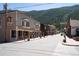 Charming street view with storefronts, flower pots, and mountain backdrop at 205 Loop Dr, Georgetown, CO 80444