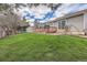 Home exterior with a large deck overlooking the well-maintained backyard and lawn at 6376 S Pierson St, Littleton, CO 80127