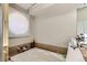 Bright bathroom displays soaking tub with a window and white interior at 6376 S Pierson St, Littleton, CO 80127