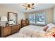 Bedroom with neutral colors, wood furnishings and a view of the neighborhood through the window at 6376 S Pierson St, Littleton, CO 80127