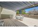 Outdoor deck featuring a striped awning and patio furniture set for outdoor enjoyment at 6376 S Pierson St, Littleton, CO 80127