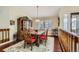 Cozy dining room featuring a wooden table, red chairs, and a stylish china cabinet at 6376 S Pierson St, Littleton, CO 80127