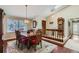 Inviting dining room with chandelier, wood floors, and natural light from the large window at 6376 S Pierson St, Littleton, CO 80127