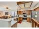 Well-lit kitchen featuring stainless steel appliances, granite countertops, and wooden cabinetry at 6376 S Pierson St, Littleton, CO 80127
