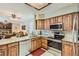 Modern kitchen with stainless steel appliances, granite countertops, and adjacent dining area at 6376 S Pierson St, Littleton, CO 80127