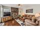 Comfortable living room features a brick fireplace, hardwood floors, and ample seating at 6376 S Pierson St, Littleton, CO 80127