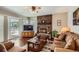 Relaxing living room with a brick fireplace, hardwood floors, and access to the outdoor deck at 6376 S Pierson St, Littleton, CO 80127