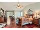 Spacious main bedroom featuring hardwood floors, a large bed, and stylish furnishings at 6376 S Pierson St, Littleton, CO 80127