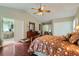 Comfortable main bedroom features vaulted ceilings, ceiling fan, hardwood floors and ensuite bath access at 6376 S Pierson St, Littleton, CO 80127