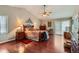 Elegant main bedroom with hardwood floors, vaulted ceilings, and access to a private balcony at 6376 S Pierson St, Littleton, CO 80127