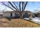 Large backyard with mature trees and deck at 6730 Ingalls St, Arvada, CO 80003