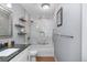 Updated bathroom with marble tile shower and granite vanity at 6730 Ingalls St, Arvada, CO 80003