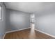 Bright bedroom with wood flooring and access to another room at 6730 Ingalls St, Arvada, CO 80003