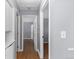 Light-filled hallway with wood flooring and access to bedrooms at 6730 Ingalls St, Arvada, CO 80003