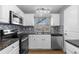 Well-lit kitchen boasts granite countertops and white cabinets at 6730 Ingalls St, Arvada, CO 80003