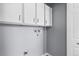 Laundry area with upper cabinets and space for a washer and dryer at 6730 Ingalls St, Arvada, CO 80003