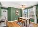 Charming dining area with green accent wall and wood table at 8117 W 90Th Dr, Westminster, CO 80021