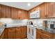 Well-equipped kitchen with wood cabinets and granite countertops at 8117 W 90Th Dr, Westminster, CO 80021