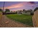 Wide backyard with fresh cut grass and wooden fence during sunset at 6413 W 76Th Ave, Arvada, CO 80003