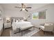 Bright bedroom featuring a ceiling fan, a large window with a view, and neutral decor at 6413 W 76Th Ave, Arvada, CO 80003