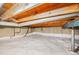 Spacious crawl space featuring clean white moisture barrier and robust support system under exposed wood beams at 6413 W 76Th Ave, Arvada, CO 80003